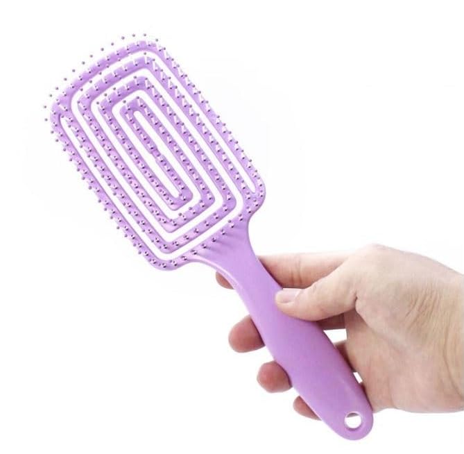 Full view of the 24cm long pastel purple Vented Detangling Hair Brush held in hand