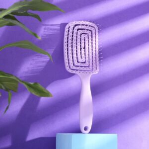 Close up of the hollow spiral design on the purple Vented Detangling Hair Brush showing the airflow gaps